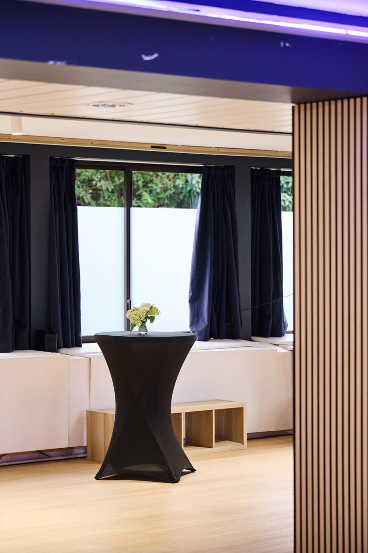Column clad in oak slats, window looking onto the greenery