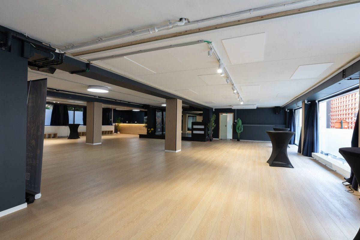 The main room empty, looking towards the counter and the oak columns